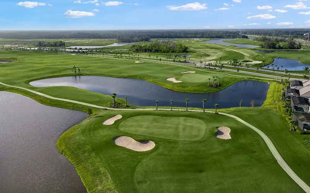 A Gulf Coast golf course from above, with lakes and palm-lined fairways